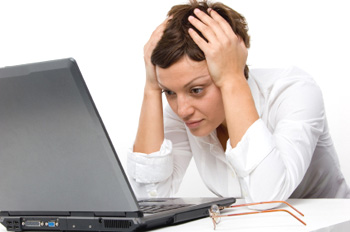 Woman at Computer Holding Head - ComputerTutorSF